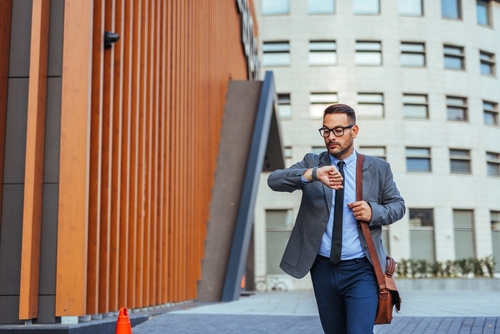 A,Professional,Businessman,Checks,His,Wristwatch,While,Walking,In,A Micro-Scheduling