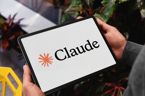 Madrid,,Spain;,05,28,2025,Businessman,Holding,A,Tablet,Displaying Claude vs ChatGPT