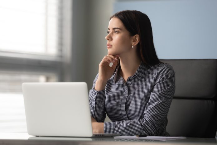 Pensive,Calm,Female,Office,Worker,Sitting,At,Desk,In,Front Quiet ambition