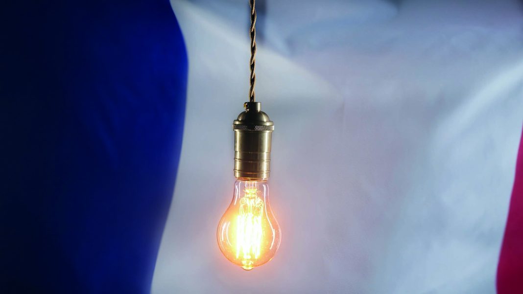 Flashing,Edison,Light,Bulb,On,French,Flag,Background.,Bad,Electricity